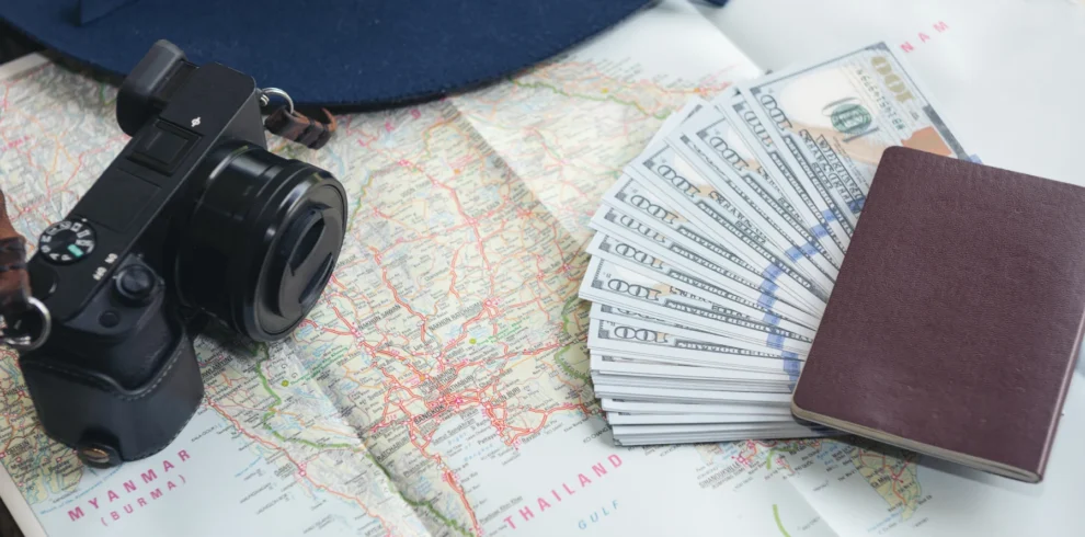 dollar-banknotes-credit-card-passport-camera-blue-hat
